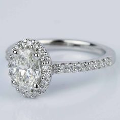 an oval cut diamond ring with pave set shoulders