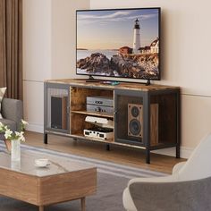 a flat screen tv sitting on top of a wooden entertainment center in a living room