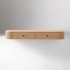 a wooden shelf sitting on top of a white wall