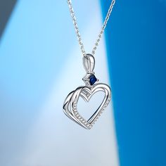 This captivating double heart necklace symbolizes love, connection, and unity. This exquisite piece features two hearts, with one heart delicately layered upon the other, creating a beautiful and harmonious design that represents the inseparable bond between two souls. At the center of the necklace rests a stunning blue stone, adding a touch of elegance and sophistication to the piece. The blue stone symbolizes trust, loyalty, and inner peace, infusing the necklace with a sense of calm and seren Elegant Birthstone Heart Pendant Necklace, Elegant Heart Pendant Necklace With Birthstone, Sterling Silver Double Heart Jewelry, Elegant Sterling Silver Double Heart Necklace, Fine Jewelry Double Heart Necklace With Heart Charm, Sterling Silver Double Heart Necklace For Anniversary, Elegant Double Heart Jewelry With Heart Detail, Double Heart Birthstone Necklaces For Anniversary Gift, Double Heart Birthstone Necklace For Anniversary