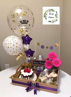 a birthday gift basket with balloons and confetti for someone's special occasion