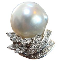 Indulge in luxury with this 14K White Gold Diamond Pearl Ring. Weighing 9 grams and perfectly sized at 5.5, this exquisite piece features a radiant pearl surrounded by sparkling diamonds, all set in solid white gold. A timeless addition to any jewelry collection. Weight: 9 g Size: 5.5 Material: 14K Solid White Gold Sell Price: $999 Appraisal Price: $2000 A free Online Diamond appraisal is included upon request Luxury Exquisite Diamond Pearl Ring, White Pearl Ring With Diamond Accents In Platinum, White Pearl Platinum Ring With Diamond Accents, White Pearl Ring With 17 Jewels For Formal Occasions, Formal White Pear-shaped Diamond Ring, White Gold Pearl Ring With High Luster Diamonds, Formal Diamond Pearl Ring With High Luster, Diamond Pearl Ring, Pearl And Diamond Ring