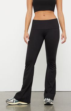 The PAC WHISPER Active Fold-Over Waistband Flare Yoga Pants from the PAC 1980 activewear collection make for the perfect piece for your next workout routine. These low-rise leggings have a fold-over waistband with flared leg openings and a tight figure-flattering fit. This piece is made with our PAC WHISPER™ fabric and has a buttery soft feel and quick-drying design that is perfect for working out or lounging around.Solid color leggings12" rise31.5" inseam22" leg openingButtery softQuick-drying4-way stretch24/7 comfortLow-riseFold-over waistbandFlared leg openingsTight fitHD silicone P logoFits true to size82% polyester, 18% spandexModel is wearing a size XSModel measurements: 5’5” height, 32” bust, 22” waist, 32” hipsPAC WHISPER™: Buttery soft and quick-drying. Perfect from the studio to Flare Leggings Low Rise, Low Rise Work Pants, Lulu Studio Pants, Low Rise Yoga Pants Outfit, Black Wide Leg Yoga Pants, Flair Leggings, Foldover Leggings, Clothes For College, Black Flare Leggings