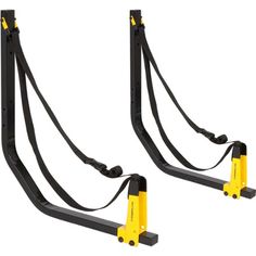 two black and yellow gym equipment with straps attached to each other on a white background