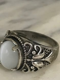 Beautiful Sterling Silver Ring, Vintage Filigree Ring, 925 Silver Chunky ring, Size 9 1/4, Estate Jewelry, Ring for Her What a lovely ring! This ring has white stone that changes shade shade gray depending on the light. I love the designs that it has on the sides. This ring has very good weight and any woman would fall in love with this ring. Perfect to give on any occasion! In great condition! Stone size 17 mm X 14 mm If you purchase more than one item in our shop, we are happy to combine them Silver Rings Handmade Antique, Cheap Retro Rings For Gifts, Affordable White Vintage Rings, Nancy Wheeler Ring, Silverchunky Rings, Luxury Vintage Silver Rings, Chunky Silver Rings Georgian, Luxury Vintage Silver Crystal Ring, Luxury Silver Vintage Jewelry