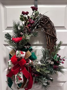 a christmas wreath hanging on the front door