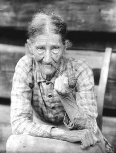 an old woman is sitting on a bench