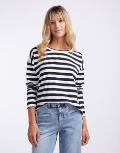 DESCRIPTION The Relaxed Long Sleeve T-Shirt in Frenchie Stripe by White & Co. Label offers a timeless addition to your casualwear collection. This top features a classic black and off-white striped pattern that exudes a relaxed yet sophisticated vibe. The long sleeves and soft fabric provide comfort and warmth, making it a perfect choice for cooler days. Pair this versatile piece with light-wash denim shorts for a sunny day out or layer it under a blazer for an effortlessly chic look. Still brow Summer Knitting, Boyfriend Tee, Light Wash Denim, White Tank Top, Sunny Day, Stripes Design, Stripes Pattern, Effortless Style, Classic Black