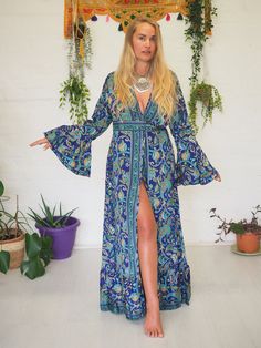 FLEETWOOD WRAP DRESS - RUBY SPARROW - TANGLED UP IN BLUE Our Signature wrap dress is back! This blue ditsy print is soft & has a floral & ethereal feel to it. The colours are soft & complimenting & the print is effortlessly beautiful. For a limited time only & with limited prints available, our Stevie Nicks inspired wrap around kimono dress is BACK! With the most beautiful billowing sleeves, buttery soft fabric and flowing frills these are some of our favourite bespoke creations ever! The tie ca Hippie Fitted Dress With Ruffles, Bohemian Fitted Dress With Kimono Sleeves, Hippie Blue V-neck Dress, Fitted Bohemian Dress With Kimono Sleeves, Blue Boho Maxi Dress In Hippie Style, Blue Boho Maxi Dress With Hippie Style, Blue Boho Maxi Dress Hippie Style, Blue Hippie Boho Maxi Dress, Bohemian Bell Sleeve Maxi Dress With Floral Print