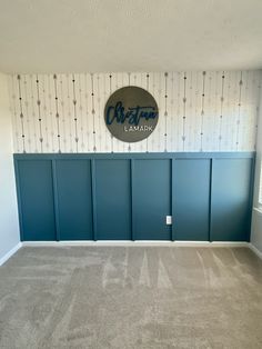 an empty room with blue walls and carpet