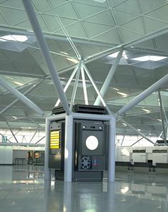 an airport terminal with several electronic devices on the floor and in front of it's ceiling