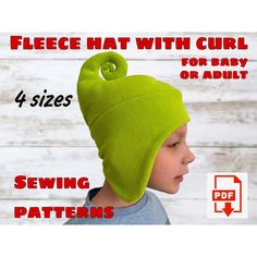 a young boy wearing a green hat with curl on the top and four sizes for baby or adult