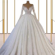 a white wedding dress with long sleeves on display