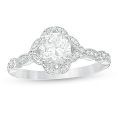 Display your romantic style with this beautiful vintage-inspired ring. Created in cool 10K white gold, this Art Deco look features a 6.0mm lab-created shimmering white sapphire wrapped in a frame of marquise shapes, each adorned with diamonds and intricate milgrain borders. Along the milgrain-lined shank, bezel-set diamonds alternate with diamond-lined marquise shapes. Radiant with 1/8 ct. t.w. of diamonds and a bright polished shine, this ring is a keepsake in the making. Vintage White Rings With Halo Setting, Classic Wedding Halo Ring With Diamond Accents, Classic White Platinum Cluster Ring, Classic White Filigree Ring With Brilliant Cut, Classic White Filigree Ring With Prong Setting, Classic White Diamond Ring With Intricate Design, Vintage White Gold Rings With Halo Design, Elegant Filigree Ring With Halo Setting, White Vintage Wedding Ring With Halo Setting