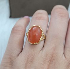 This Ring comes with a 100% Natural Carnelian Gemstone and it is made up of 925 solid sterling silver. This ring is handcrafted by our skilled craftsmen and designed by us. Every gemstone is handpicked for the best quality. Materials:- Silver (925 Solid Sterling Silver) Gemstone:- Natural Carnelian. Item Weight :- approx. 4 Grams Stone Weight :- 10 CTS Stone Size :- 12x16 MM Stone Shape :-  Oval Cab Select Size in Variation , if you don't find perfect size please buy any size and message us your Formal Gold Carnelian Ring, Formal Carnelian Gold Ring, Yellow Gold Carnelian Oval Cabochon Ring, Yellow Gold Oval Cabochon Carnelian Rings, Carnelian Yellow Gold Rings With Oval Cabochon, Elegant Orange Carnelian Rings, Oval Natural Stone Rings For Weddings, Carnelian Jewelry With Polished Finish For Weddings, Oval Natural Stone Wedding Ring