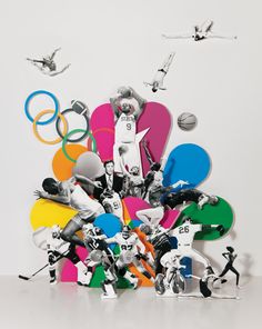 a group of toy figurines standing next to each other in front of an olympic symbol