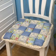 a wooden chair with blue and white cushions