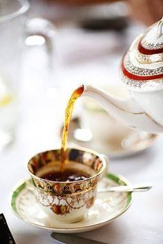 tea being poured into a cup on a saucer