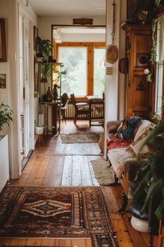 a living room filled with furniture and lots of plants