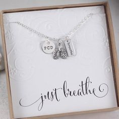 "A beautiful necklace displayed perfectly on a gift card of your choice\". This necklace is perfect for so many things!! It reminds us to slow down, reduce stress, and breathe. It's the perfect awareness necklace or simply show your support for a loved one affected by a lung disorder. Included is an 11mm round initial disc, an 18x12mm lung charm, and a 15x7mm \"Breathe\" charm. The standard chain is a sturdy 18\" flat cable chain. 16\" and 20\" are also available. Please include the following in Spiritual Pendant Jewelry For Best Friend Gift, Spiritual Pendant Jewelry As Best Friend Gift, Customizable Sterling Silver Charm Necklace For Best Friend, Handmade Spiritual Necklaces For Best Friend Gift, Handmade Spiritual Necklace For Best Friend, Personalized Spiritual Necklaces As Gifts, Inspirational Handmade Necklaces For Gifts, Inspirational Handmade Necklace For Gift, Inspirational Handmade Necklace Gift