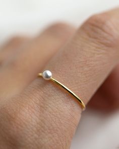 Small Swarovski Pearl Stacking Ring - It's a simple and classic everyday ring that adds a tiny beauty to your finger :) Perfect as a stacking ring or by itself. This elegant Tiny Pearl ring is made with 14K gold filled / sterling silver. ■ Tiny CZ ring can be found here: https://www.etsy.com/listing/588154122/small-diamond-cz-ring-dainty-stacking?ref=shop_home_active_1 ■ SHIPPING UPGRADES You can find shipping upgrades options in the drop bar menu when you check out. * Within the U.S Regular Fir Simple Pearl Ring As A Gift, Minimalist Pearl Drop Ring For Wedding, Elegant Everyday Birthstone Ring With Round Band, Minimalist Wedding Pearl Ring With Pearl Drop, Dainty Stackable Pearl Promise Ring, Minimalist Pearl Open Ring For Promise, Minimalist Pearl Stackable Jewelry, Tiny Minimalist Pearl Ring For Gift, Minimalist Adjustable Pearl Ring With Charm