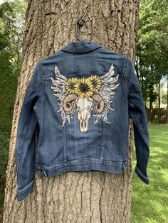 This is an upcycled denim jacket size medium ( see photos for measurements) Painted with professional quality paint and heat set for permanence with a boho tattoo design .. great for fall . If you don't see a design you like or need another size hop on over to my custom listing and message me Bohemian Distressed Denim Jacket, Western Style Cotton Denim Jacket For Fall, Denim Blue Jacket For Fall Festival, Bohemian Fitted Denim Jacket For Fall, Fitted Bohemian Denim Jacket For Fall, Bohemian Medium Wash Denim Jacket For Fall, Bohemian Fall Denim Jacket In Medium Wash, Hippie Cotton Denim Jacket For Fall, Western Style Denim Blue Jacket For Fall