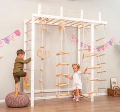 two young children playing in a play room