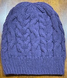 This beanie is knitted in a fun lightweight Cable Knit slouchy style that will help you stay warm during the chilly seasons while still looking stylish.  The great purple  color will go with any outfit in your wardrobe and fun for fall.  Each  beanie is knitted with love and the hope that you or whomever you gift it to will love it for years to come.  Already soft, and will only get softer the longer you love it Easy care,  wash on gentle and dry on low heat or allow to air dry.  Part of the pro Slouchy Style, Slouchy Beanie, Skull Cap Beanie, Skull Cap, Pacific Northwest, Purple Color, Air Dry, Cable Knit, Stay Warm