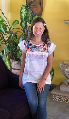 Beautiful traditional Mexican blouse made on a pedal loom with floral motifs, hand-embroidered in bright thread. Blouses have unique embroidery so may vary. Mexican textile art has centuries of history and creativity throughout the country. Mexico is recognized as one of the leading countries with a beautiful artistic production in the textile world, miraculous hands of talented artisans from different states of the country create stunning embroidery clothing, and various items. #Oaxaca #Chiapas Bohemian Embroidered Top With Multicolor Floral Embroidery, Bohemian Embroidered Top With Multicolor Floral Design, Bohemian Multicolor Floral Embroidered Top, Bohemian Blouse With Embroidered Hem For Festivals, Traditional Multicolor Embroidered Top With Embroidered Sleeves, Folk Peasant Top With Multicolor Embroidered Neckline, Cotton Blouse With Multicolor Embroidered Sleeves, Cotton Blouse With Multicolor Embroidery And Embroidered Sleeves, Festival Embroidered Top With Hem Detail