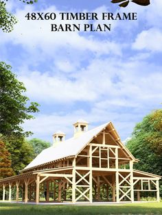 a large wooden barn sitting in the middle of a field