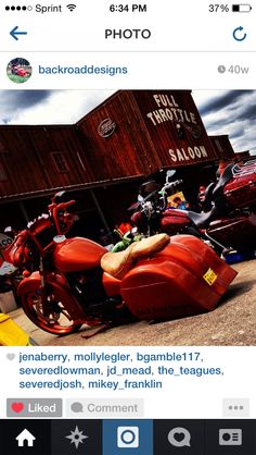 a red motorcycle parked in front of a building