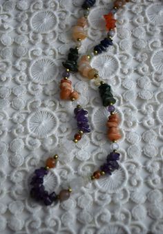 Vintage multicolored gemstone beaded necklace, featuring amethyst, carnelian, crystal quarts, onyx, agate. The necklace consists of one strand of stone chip beads, arranged by color with brass spacers between the different type of gemstones. Closes with screw barrel clasp at the back Era - 1980s Approx. Length (with clasp) - 24 inches / 61 cm Condition - Very good vintage condition, some dents on the stones! Dainty Multicolor Gemstone Bead Necklaces, Dainty Multicolor Gemstone Beaded Necklaces, Dainty Multicolor Gemstone Bead Necklace, Vintage Gemstone Beads Jewelry For Healing, Handmade Dainty Multicolor Crystal Necklace, Dainty Handmade Multicolor Crystal Necklaces, Dainty Round Gemstone Beaded Necklace, Bohemian Amethyst Beaded Necklaces For Jewelry Making, Bohemian Jewelry With Gemstone And Mineral Crystal