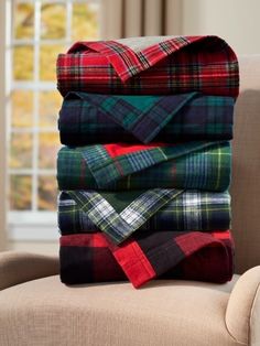 a pile of blankets sitting on top of a chair