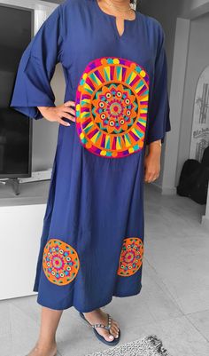 An elegant summer dress/kaftan with Saharan floral patterns. The texture of the Egyptian cotton gives the The beautiful saharan floral patterns on this navy blue kaftan give your summer outfit a dash of exotic opulence together with a sturdy fabric quality.  With its straight design bust to waist ratio of 1:1 its is sure to give the relaxed feel of almost wearing the lightest of dresses. A new look for your summer where this dress/kaftan takes you everywhere from the beach to summer night parties to even casual day errands.  Fabric: 90% Egyptian Cotton-20% polyester Egyptian cotton is extraordinary - producing extra-long fibres that are smaller in diameter than regular cotton. These longer, finer fibres create super smooth yarns when combed and spun, and therefore super smooth, soft cloth Embroidered V-neck Kaftan For Navratri, V-neck Embroidered Kaftan For Navratri, Multicolor Resham Embroidered Kaftan For Navratri, Multicolor Resham Embroidery Kaftan For Navratri, Navratri Multicolor Resham Embroidery Kaftan, Multicolor Resham Embroidery Kaftan In Straight Kurta Style, Traditional Embroidered Tunic Maxi Dress, Blue Embroidered Straight Kurta Kaftan, Tunic Dresses For Navratri Festival