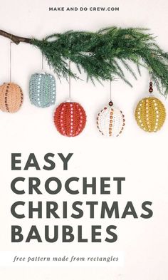 crochet christmas baubles are hanging from a tree branch