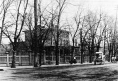 an old black and white photo of people walking down the street