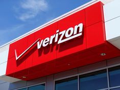 a verizon store sign on the side of a building with blue skies in the background