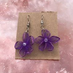 Lightweight, small size, purple flower earrings!  🌈 Handmade 🌈 🌸 Fabric flower with a bead center! 🌸 💗 Customization available! 💗 Message me if you have any questions and we can work on making your idea come to life! Processing time for orders is 3-5 business days If you need it sooner message me and we can upgrade you to Priority shipping (1-3 business days) or give you an estimated processing time! Lavender Flower-shaped Earrings For Gifts, Elegant Purple Flower Earrings, Elegant Purple Flower Shaped Earrings, Purple Flower Earrings With Ear Wire For Gift, Purple Flower Earrings With Ear Wire As Gift, Elegant Lavender Flower Earrings With Ear Wire, Adjustable Purple Flower Earrings As Gift, Adjustable Purple Flower Earrings For Gift, Handmade Lavender Earrings As Gift