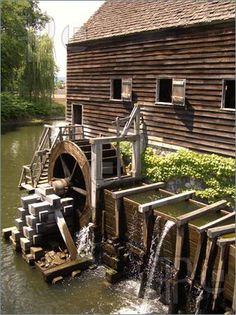 an old mill with water coming out of it