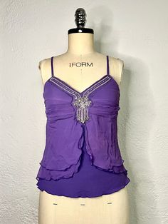 Here we have an exquisite purple blouse with spaghetti straps, a sequin design on the front, and stretch fabric by Anonymous. This women's tank top is vintage from the 90s. Having a sleeveless blouse in your collection is essential for summer. This camisole top can be worn to a formal event or paired with jeans for a more casual look. Thanks for visiting, check out our shop for more vintage and retro finds, Limited stock, so buy now! Measurements: Armpit to armpit: 30 inches Back length: 23 inch Y2k Style Camisole Top For Party, Fitted Sleeveless Blouse Tank Top For Evening, Purple Spaghetti Straps Top For Summer, Y2k Cami Tank Top For Party, Y2k Style Tank Top For Party, Purple Stretch Blouse For Party, Fitted Purple Tank Top For Spring, Fitted Purple Camisole For Spring, Fitted Purple Tank Top For Night Out