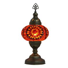 an orange and black lamp on a white background