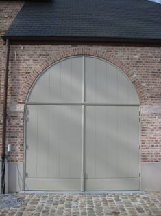 a brick building with two large white doors