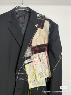 a black suit with red and green thread on it