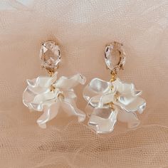 Emulating the ruffles on a ballerina, this earring is dainty, unique and completely weightless. The faceted stone brings light to your face and is extremely flattering. The ruffle like lines are feminine and flirty all at once. Earrings are handmade and turnaround time can vary up to 2 weeks Elegant Evening Flower Drop Earrings, Elegant Flower Drop Earrings For Evening, Elegant Pearl White Earrings For Party, Elegant Faceted Party Earrings, Elegant Faceted Earrings For Party, Delicate White Crystal Earrings For Party, Elegant Faceted Chandelier Earrings, White Crystal Earrings With Elegant Design For Party, Chic Flower Earring For Wedding