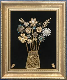 a painting with flowers in a vase on a black background and gold trimmings