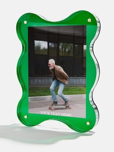 a man riding a skateboard down a street in front of a green frame that says your best move