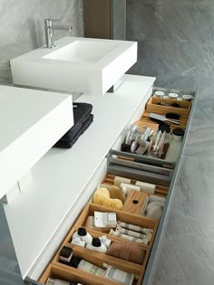 a bathroom with two sinks and drawers in it