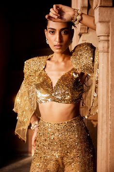 A bold three piece dress in sheer fabric, a glamorous embellished gold bralet paired with sheer trousers with splatter embroidery of sitara/patra and a matching sheer jacket with power shoulder highlighted with gold embellishments Three Piece Dress, Indian Wedding Dress Traditional, Indo Western Outfit, Gold Bralette, Net Jacket, Sheer Jacket, Gold Pants, Set Saree, Saree Gown