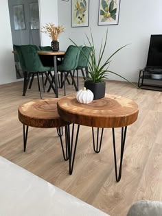 two wooden tables with hairpin legs in a living room next to a table and chairs