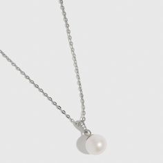 Indulge in elegance with this luminous white freshwater pearl necklace, the perfect match for any occasion. Featuring a timeless gem and a blend of classic and contemporary design, it is thoughtfully curated to highlight your unique style and leave a lasting impression of sophistication. Classic White Gold Pearl Necklace As Gift, Pearl White Timeless Necklace For Anniversary, White Classic Necklace With Delicate Chain, Elegant White Gold Solitaire Necklace With Delicate Chain, Classic Pearl Necklace With Delicate Chain, Elegant Pearl Jewelry With Pearl Pendant, Formal Fine Jewelry Pearl Clavicle Necklace, Silver Jewelry With Pearl Charm In Refined Style, Dainty Silver Pearl Necklace